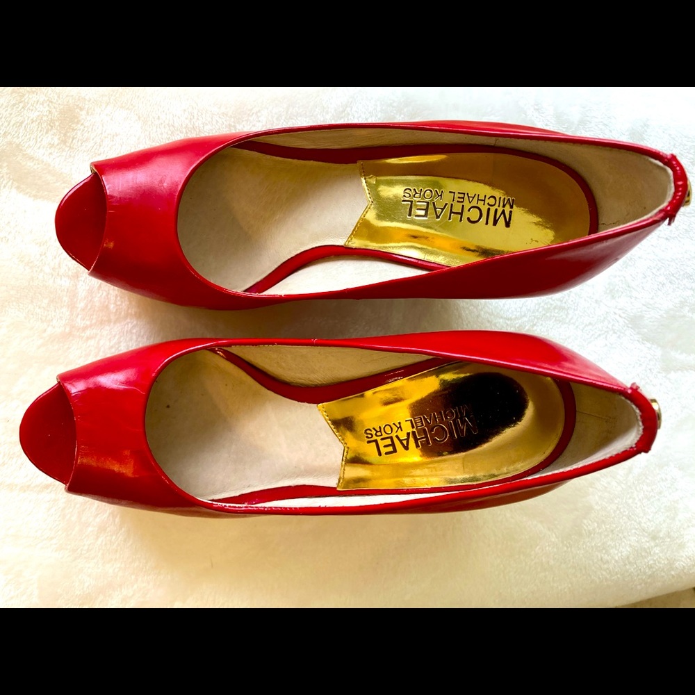 A Michael Kors red wedge shoe.